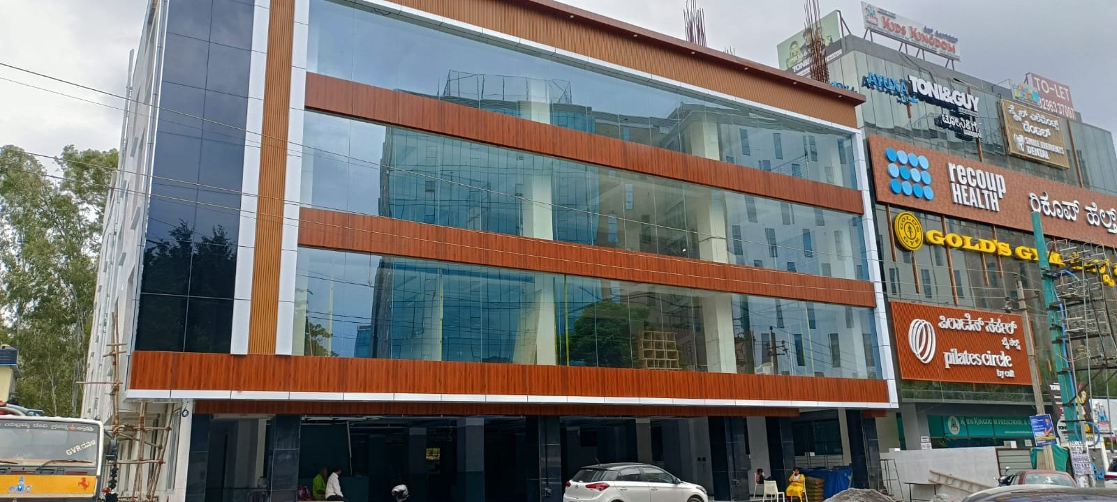 Glass Facade Commercial Building Exterior, exterior works by Dhrithi Infra