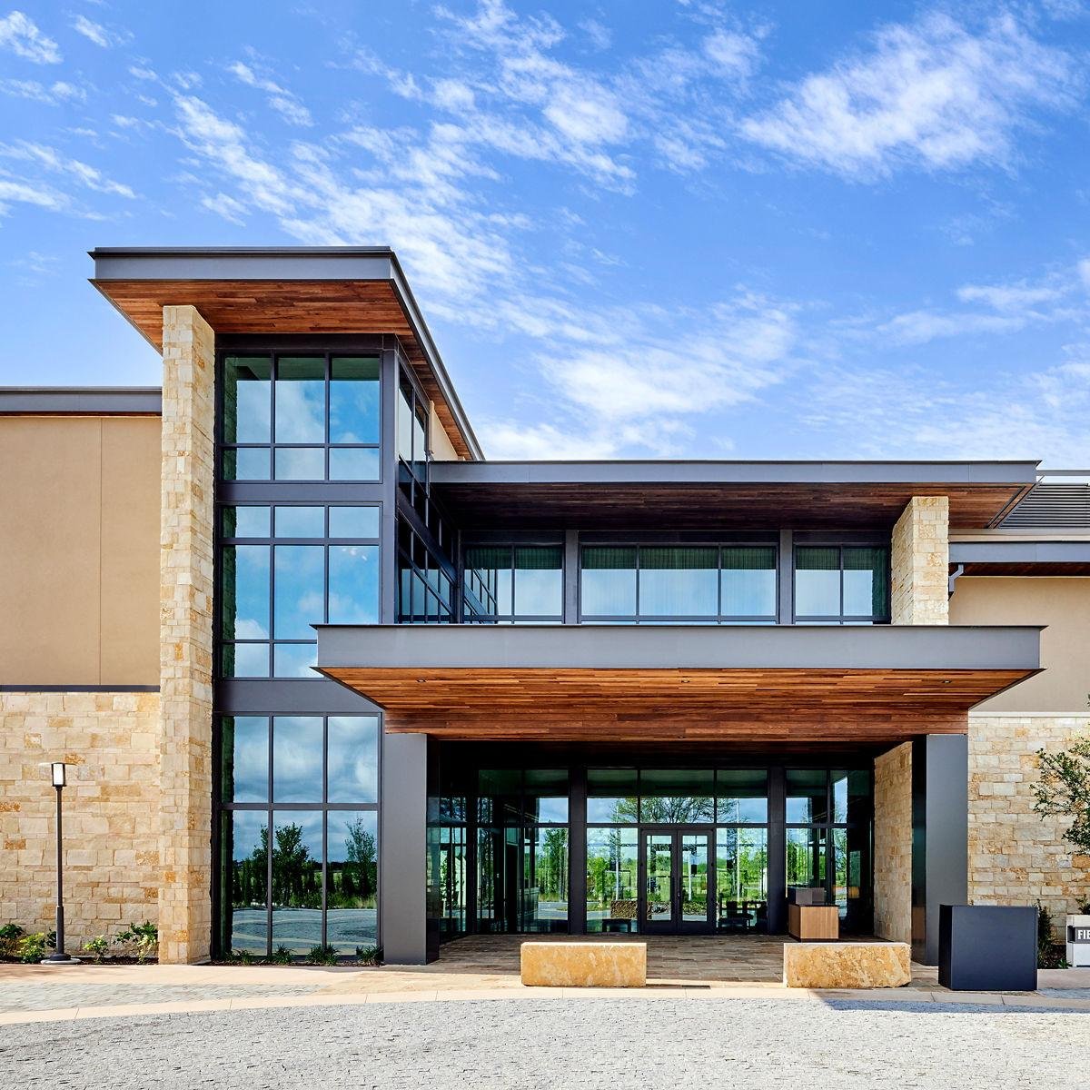 Hotel elevation mixing glazing, louvers and stone bands