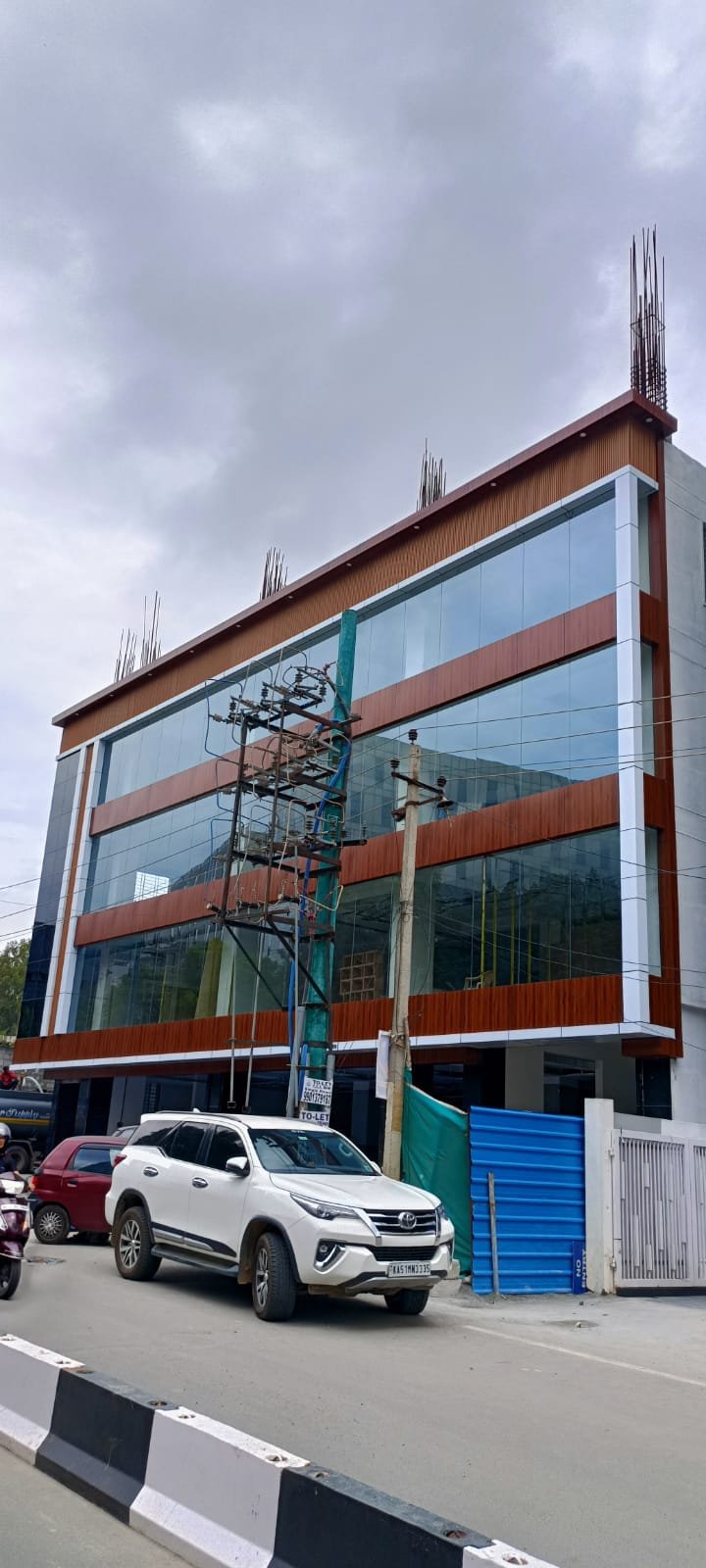 Modern Office Building Front Elevation, exterior works by Dhrithi Infra