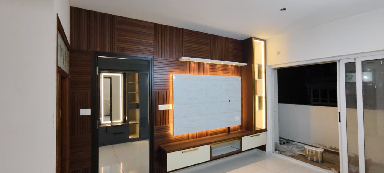 Modern Wooden Fluted TV Unit with Marble Back Panel, aluminium interiors by Dhrithi Infra